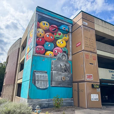 Emoji Dispenser mural by Leon Keer