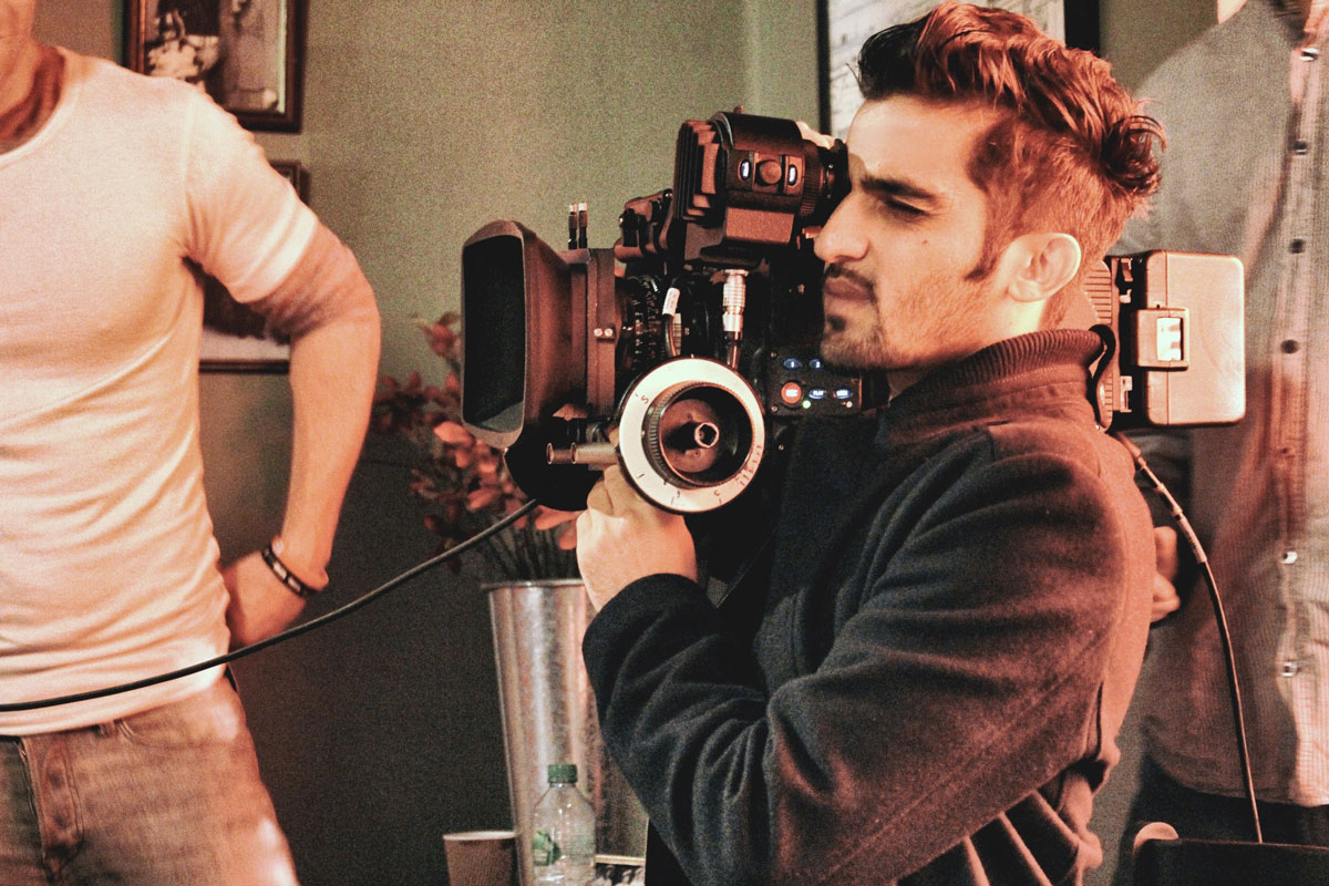 filmmaker holding camera while shooting a film