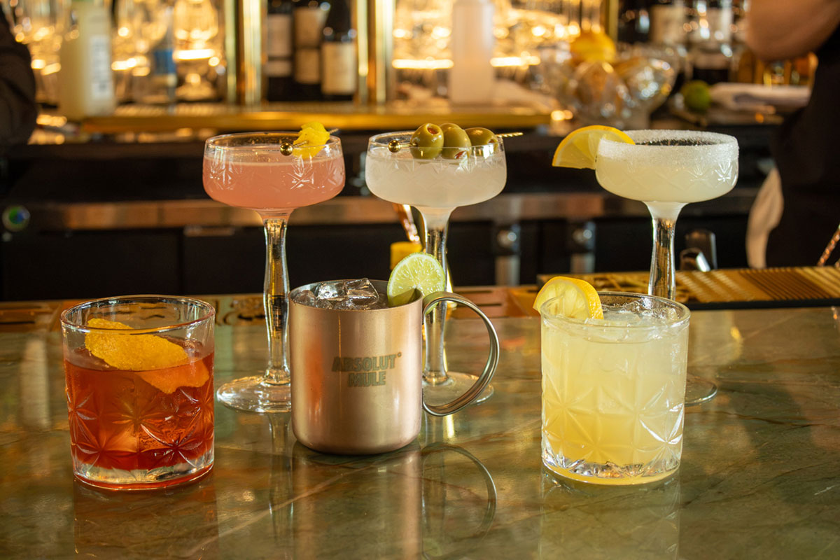 group of cocktails sitting on the bar at 1834 Tavern Lafayette