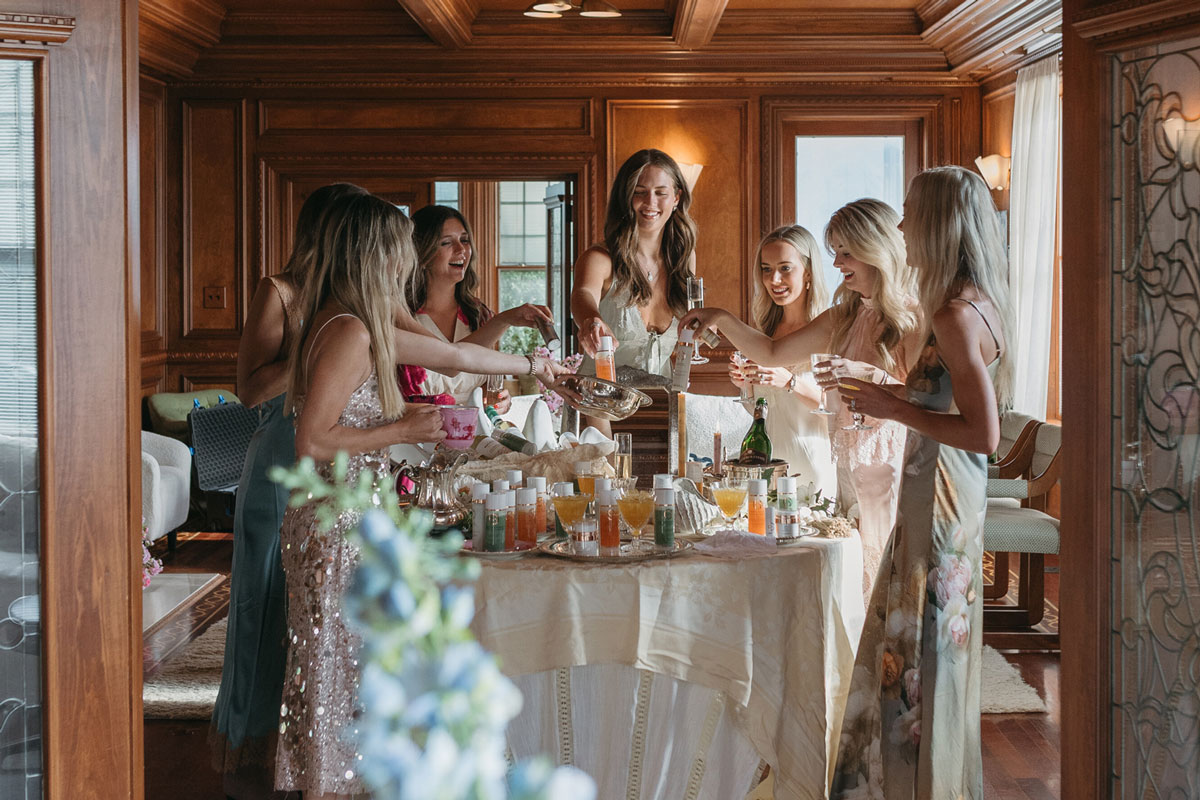 A group of women with beverages toasting each other. 