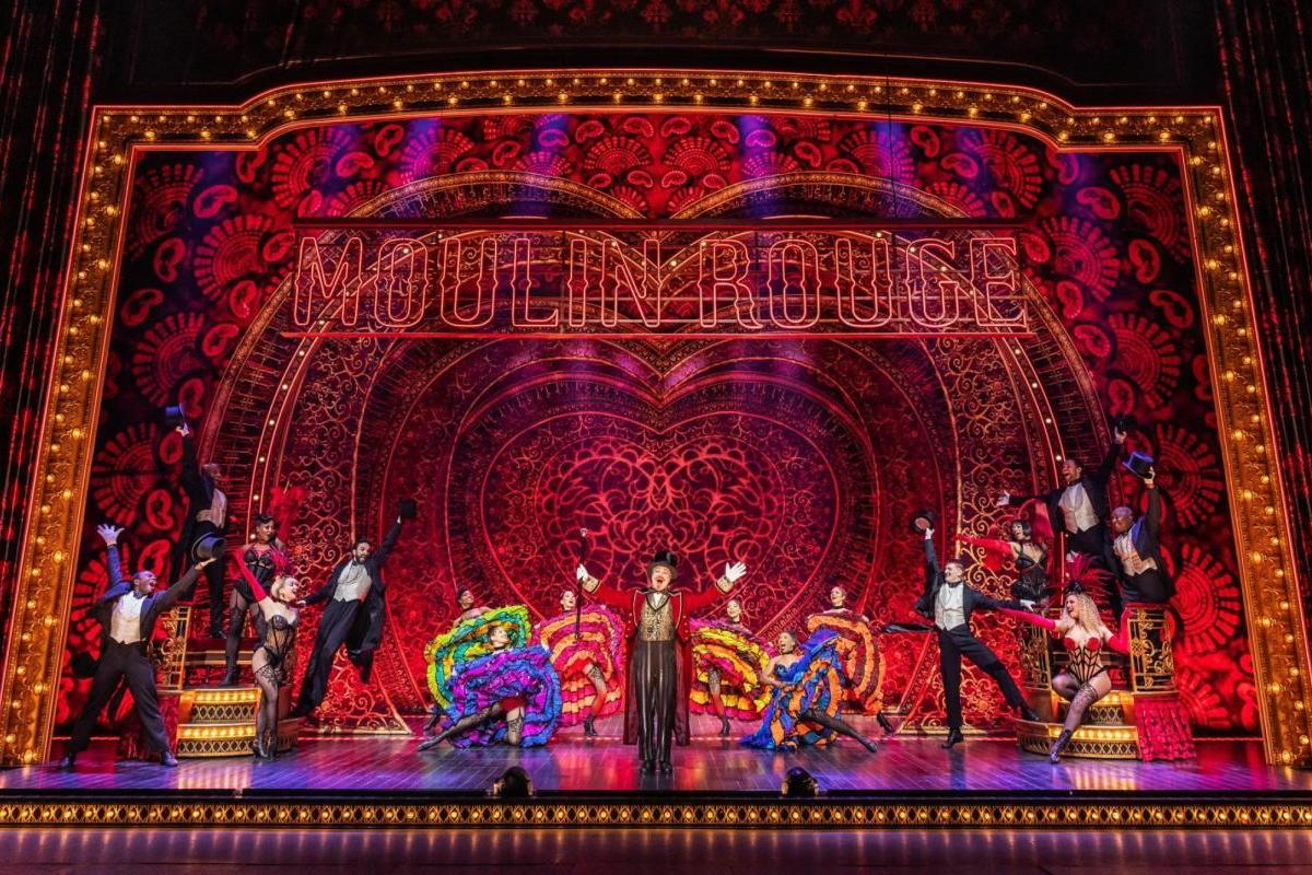 CanCan dancers and male dancers on colorful stage 