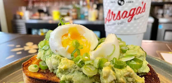 Avocado and egg toast with Arsaga's cup in the background