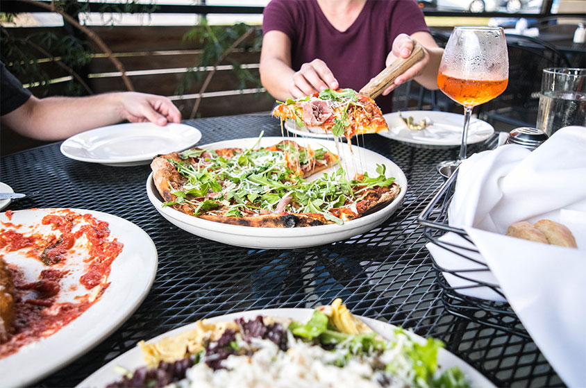 People running in the forest and crossing wooden bridge