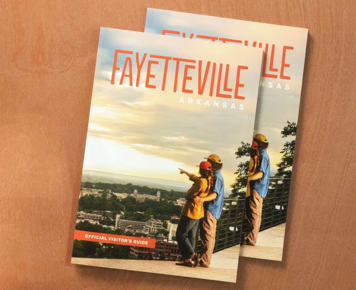 stack of visitors guides for Fayetteville, Arkansas